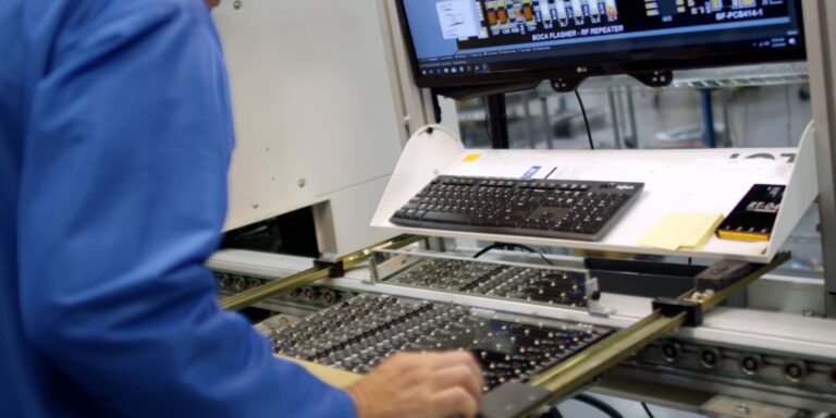 A worker building electrical components for lighting