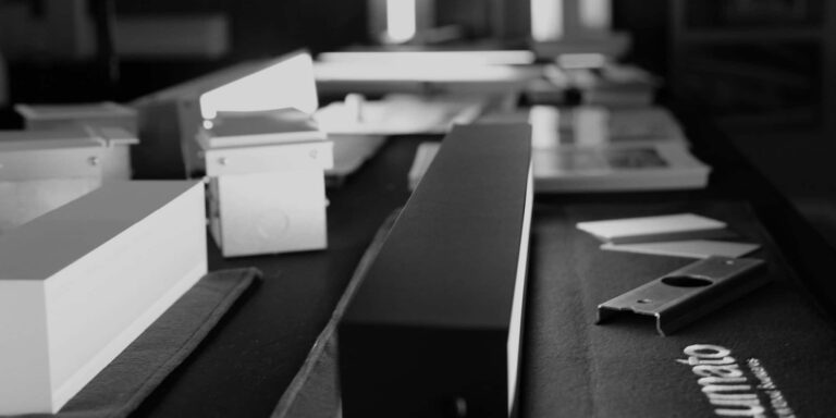 Linear light fixtures being assembled