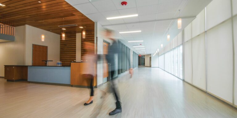 An edited photo showcasing recessed lighting in a hallway