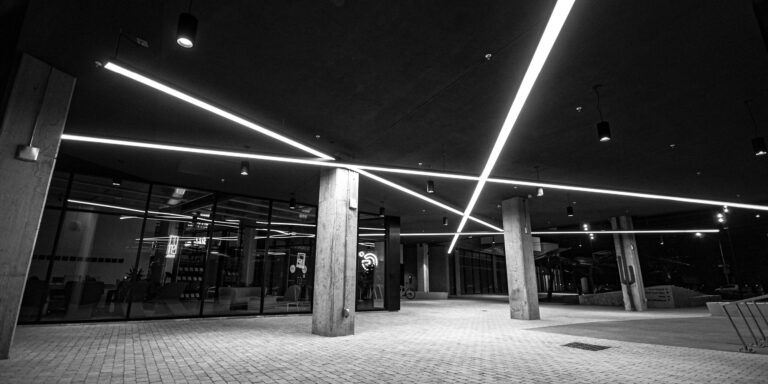 Photo of linear lighting under the canopy of an apartment complex entryway